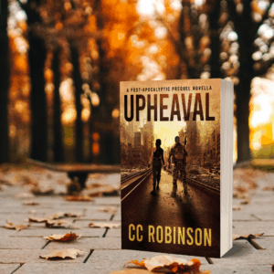 Upheaval paperback on a fall background with orange leaves and dappled sunset